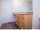 Bathroom with wood vanity and mirror over wood-look floor at 2326 Bigwood Trl, Atlanta, GA 30349