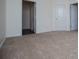 Cozy bedroom featuring neutral carpet and multiple doors for easy access to other areas at 2326 Bigwood Trl, Atlanta, GA 30349