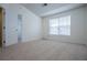 A bright bedroom featuring a window with blinds and neutral carpeting at 2326 Bigwood Trl, Atlanta, GA 30349