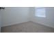 A bright bedroom featuring a window with blinds and neutral carpeting at 2326 Bigwood Trl, Atlanta, GA 30349