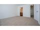 Carpeted bedroom with white walls and doorway view to the bathroom at 2326 Bigwood Trl, Atlanta, GA 30349