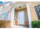 A cozy front entryway with a white door, brick accents, and well-kept shrubs at 2326 Bigwood Trl, Atlanta, GA 30349