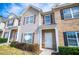 A charming townhouse with neutral siding, shutters, and well-maintained landscaping at 2326 Bigwood Trl, Atlanta, GA 30349