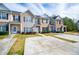 Front exterior view of townhouses showing driveways, landscaping, and design variety at 2326 Bigwood Trl, Atlanta, GA 30349