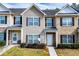 Inviting townhouse exterior with neutral siding, shutters, and well-maintained landscaping at 2326 Bigwood Trl, Atlanta, GA 30349