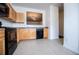 Bright kitchen with light wood cabinets, tile floors, and black appliances at 2326 Bigwood Trl, Atlanta, GA 30349