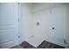 Bright laundry room featuring white walls, wood-look floors, and wire shelving at 2326 Bigwood Trl, Atlanta, GA 30349