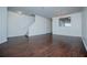 Well-lit living space featuring hardwood floors, staircase access, and a partial kitchen view at 2326 Bigwood Trl, Atlanta, GA 30349