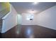Open-concept living space with hardwood floors, a decorative chandelier, and a staircase to upper level at 2326 Bigwood Trl, Atlanta, GA 30349