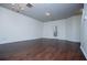 Bright living room featuring hardwood floors, white walls, and a door leading to the exterior at 2326 Bigwood Trl, Atlanta, GA 30349