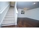 Inviting living room showcasing carpeted stairs, hardwood floors, and a glimpse of the kitchen at 2326 Bigwood Trl, Atlanta, GA 30349