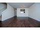 Inviting living area with hardwood floors, staircase, and a view into the adjacent kitchen area at 2326 Bigwood Trl, Atlanta, GA 30349