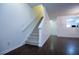 Living room with carpeted stairs, hardwood floors, and a view into the adjacent kitchen area at 2326 Bigwood Trl, Atlanta, GA 30349