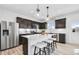 Modern kitchen with stainless steel appliances, a center island, and dark wood cabinets at 120 Aj Welch Jr Way, Mcdonough, GA 30252