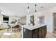 Open concept kitchen with an island and pendant lights next to a dining table at 120 Aj Welch Jr Way, Mcdonough, GA 30252