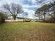 Large backyard with a shed and a partial view of the house at 2056 Merle Se Dr, Conyers, GA 30013