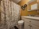 Bathroom featuring patterned shower curtain, neutral sink and toilet at 2056 Merle Se Dr, Conyers, GA 30013