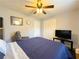 Bedroom with hardwood floors, ceiling fan and TV at 2056 Merle Se Dr, Conyers, GA 30013