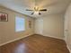 Bedroom featuring hardwood floors, ceiling fan, and a closet at 2056 Merle Se Dr, Conyers, GA 30013