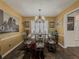 Elegant dining room featuring hardwood floors, a chandelier, and a formal dining table with seating at 2056 Merle Se Dr, Conyers, GA 30013