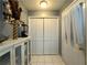 Hallway leading to closet, tile flooring, and neutral paint at 2056 Merle Se Dr, Conyers, GA 30013