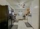 Well-lit kitchen featuring white cabinets, stainless steel appliances, and tile flooring at 2056 Merle Se Dr, Conyers, GA 30013