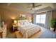 Tranquil main bedroom features a tray ceiling, neutral decor, large windows, and an ensuite bathroom at 392 Summerfield Xing, Acworth, GA 30101