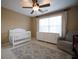 Cozy Bedroom featuring a crib, dresser, rocking chair, and a patterned rug on the floor at 392 Summerfield Xing, Acworth, GA 30101