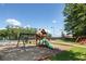 Community playground featuring a swing set and slide, plus a swimming pool and tennis court in the background at 392 Summerfield Xing, Acworth, GA 30101