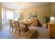 Elegant dining room featuring a chandelier, a large wooden table, and ample natural light from the bay window at 392 Summerfield Xing, Acworth, GA 30101