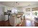 Bright kitchen with white cabinets, granite countertops, and an island with seating, ideal for casual dining at 392 Summerfield Xing, Acworth, GA 30101