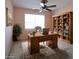 Home office featuring a rustic desk, wooden bookcase, and a comfortable chair for a productive workspace at 392 Summerfield Xing, Acworth, GA 30101