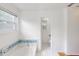 Bright bathroom featuring a soaking tub with blue accent tiles and a window at 4422 Wellington Ter, Decatur, GA 30035