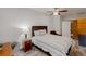 Well-lit bedroom includes a queen bed, nightstand, desk, and a door to another room at 4422 Wellington Ter, Decatur, GA 30035