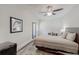 Neutral bedroom features a framed architectural print, a small desk, and a comfortable bed with a striped comforter at 4422 Wellington Ter, Decatur, GA 30035