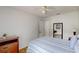 Bright bedroom with wood floors, a dresser, and a bed reflected in a mirror by the doorway at 4422 Wellington Ter, Decatur, GA 30035