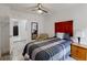 Cozy bedroom with gray wood floors, a queen bed, nightstand, and a mirror reflecting the room at 4422 Wellington Ter, Decatur, GA 30035