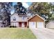 Charming two-story home with a brick facade, attached garage, and well-maintained lawn at 4422 Wellington Ter, Decatur, GA 30035