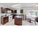 Bright kitchen with a center island, tiled floors, dark cabinetry, and natural light at 4422 Wellington Ter, Decatur, GA 30035