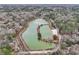 Stunning aerial view of a pond surrounded by lush trees and greenery at 447 Hemlock Dr, Pine Lake, GA 30083