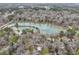 Aerial view of a lake surrounded by dense trees and houses, showcasing a serene and natural setting at 447 Hemlock Dr, Pine Lake, GA 30083