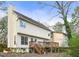 Home's backyard featuring a deck with stairs, siding, trimmed grass, and partially wooded area at 447 Hemlock Dr, Pine Lake, GA 30083