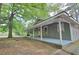 Charming home exterior featuring a spacious porch perfect for relaxing outdoors at 447 Hemlock Dr, Pine Lake, GA 30083