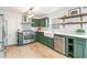 Modern kitchen with green cabinets, stainless steel appliances, farmhouse sink, and open shelving at 447 Hemlock Dr, Pine Lake, GA 30083