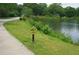 Scenic view of the lake with a 'Turtle Xing' sign, highlighting the local wildlife at 447 Hemlock Dr, Pine Lake, GA 30083