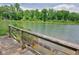 Picturesque lake view from a wooden bridge, enhancing the natural beauty of the landscape at 447 Hemlock Dr, Pine Lake, GA 30083