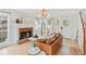 Bright living room featuring hardwood floors, a brick fireplace, and a stylish leather sofa at 447 Hemlock Dr, Pine Lake, GA 30083