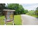 Street view of community with a sign and beautiful greenery at 447 Hemlock Dr, Pine Lake, GA 30083