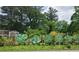 Creative yard art adds a whimsical touch to the property at 447 Hemlock Dr, Pine Lake, GA 30083