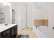 Bright bathroom featuring a bathtub, modern vanity, and a glass-enclosed shower at 1945 Bay Beauty Ln # 10, Austell, GA 30106